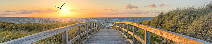 Holzsteg zum Meer im Sonnenuntergang